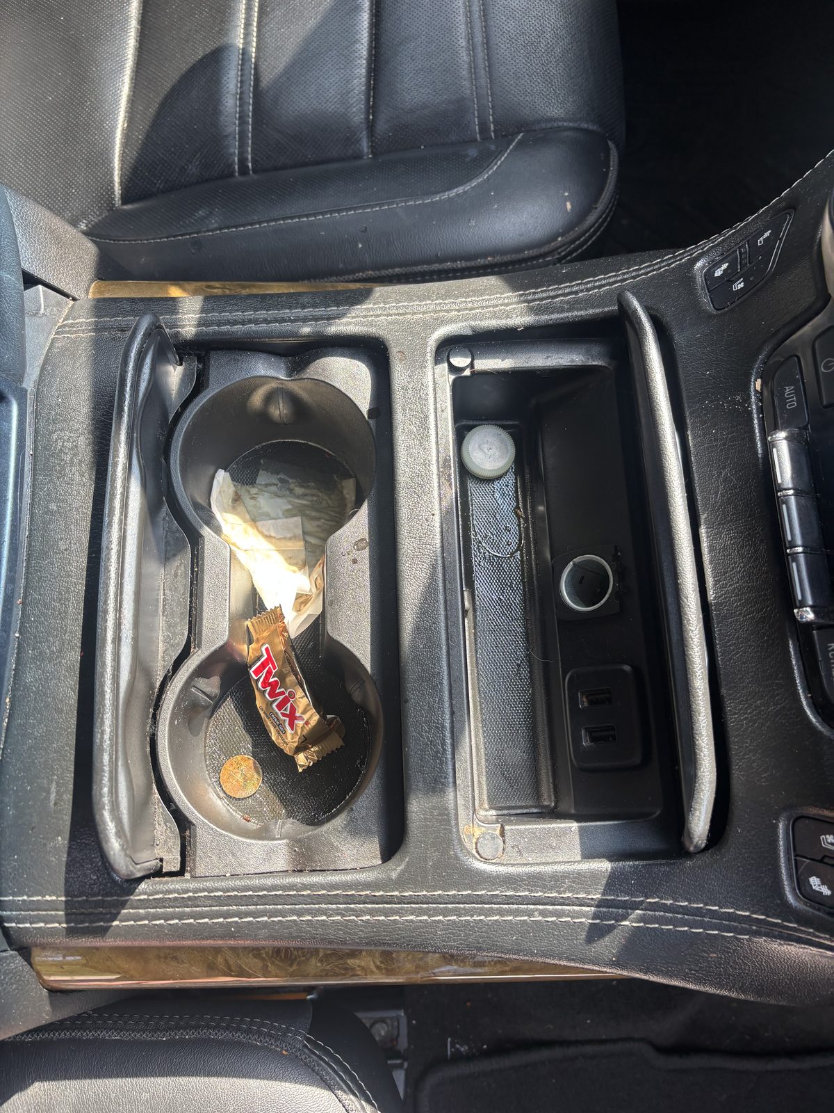 GMC Yukon Denali console and cup holders before an interior detail