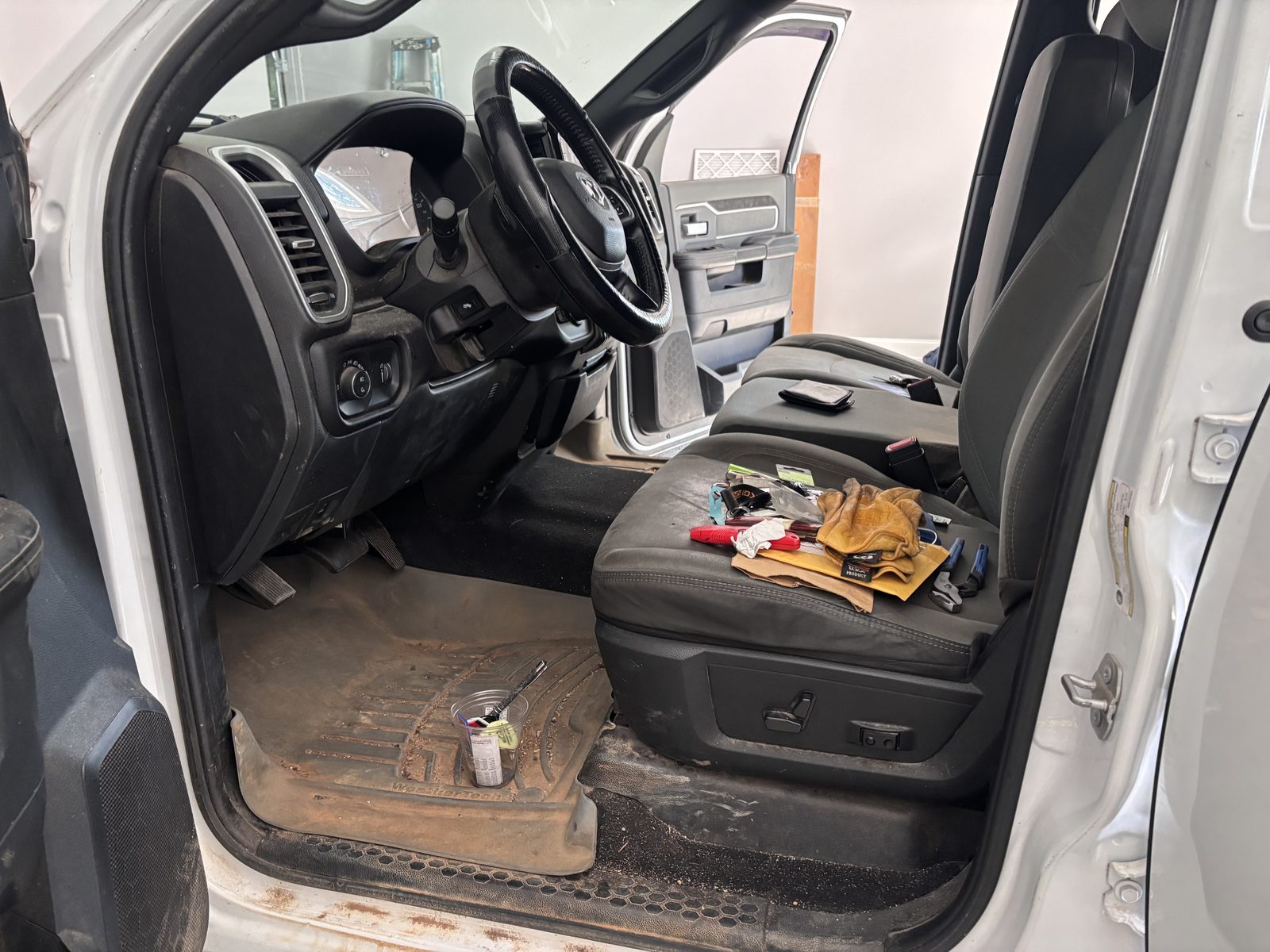 Muddy floor mats and dusty cab before interior detail — RAM 1500